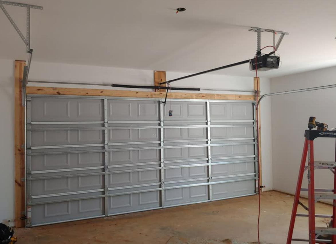 a technician from Garage Door Repair Services Weston FL performing a garage door replacement, demonstrating professional installation services.