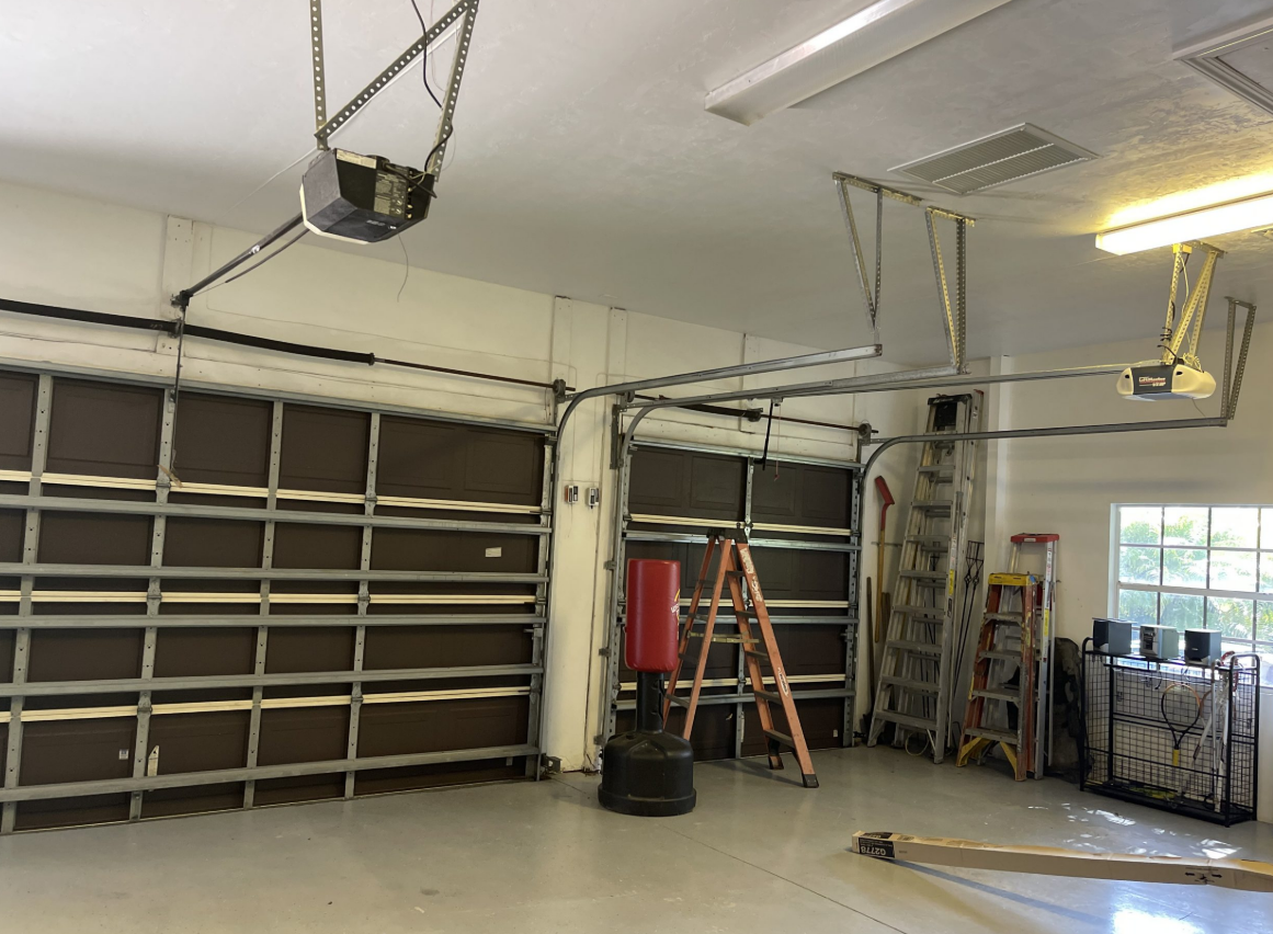 Professional technician performing garage door repair in Weston, FL, ensuring optimal functionality and safety for residential properties.