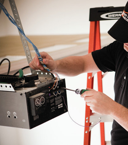 A professional technician repairing a garage door opener in Weston, FL, highlighting our expert garage door opener repair services.