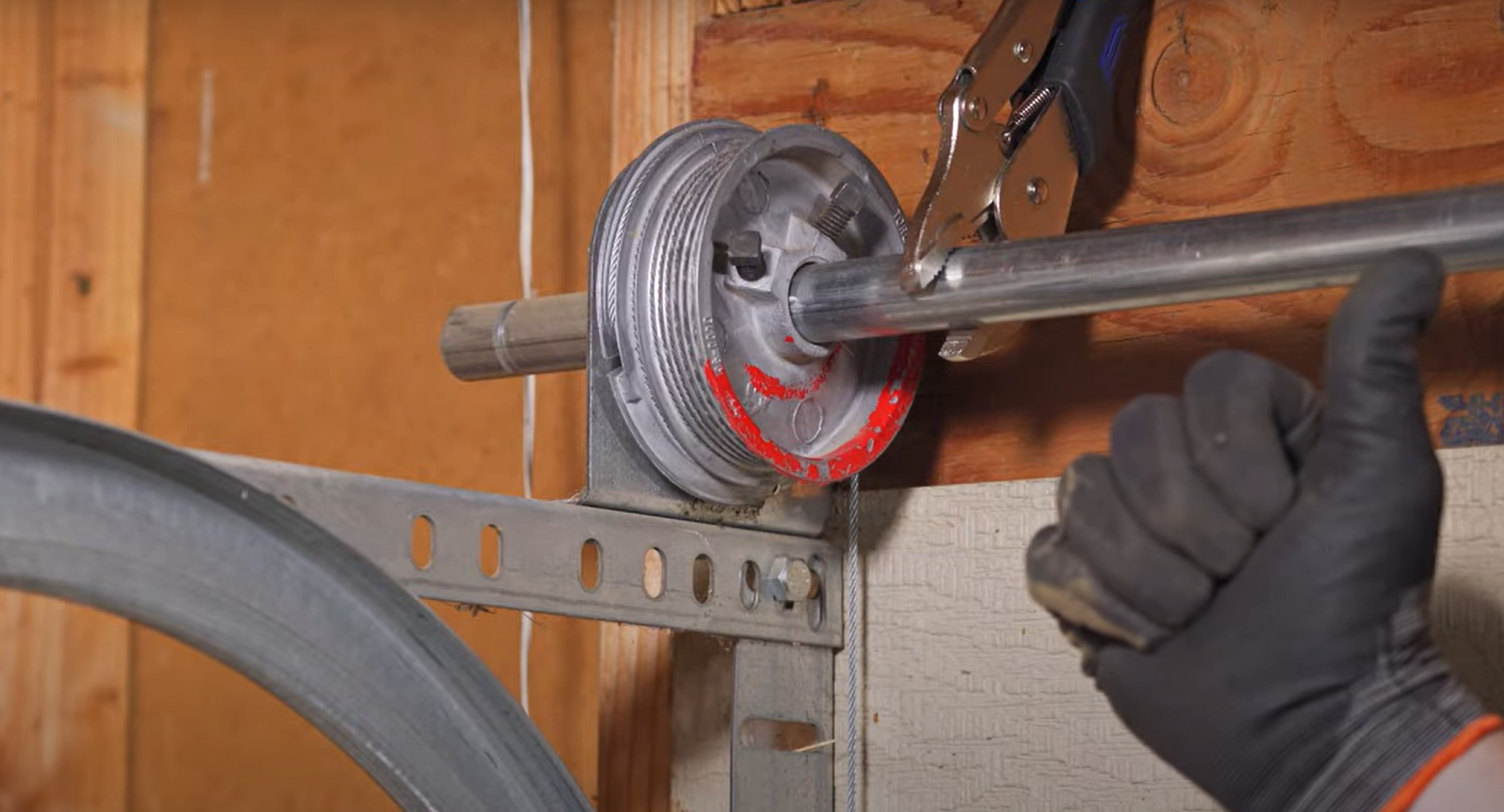 A skilled technician examining a garage door cable for repair in Weston, FL, representing Garage Door Repair Services.