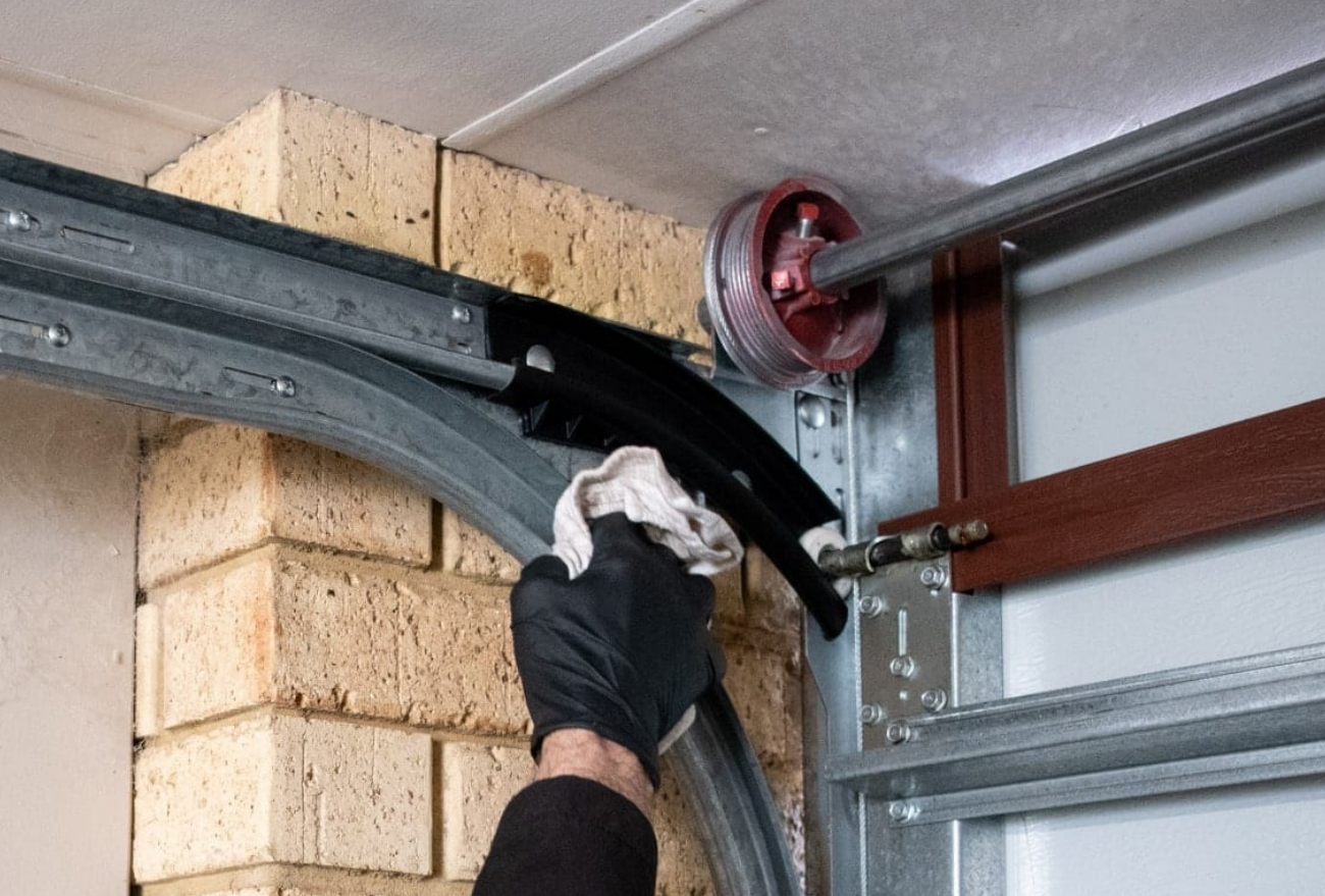 Professional technician performing garage door track repair in Weston, FL for enhanced functionality and safety.