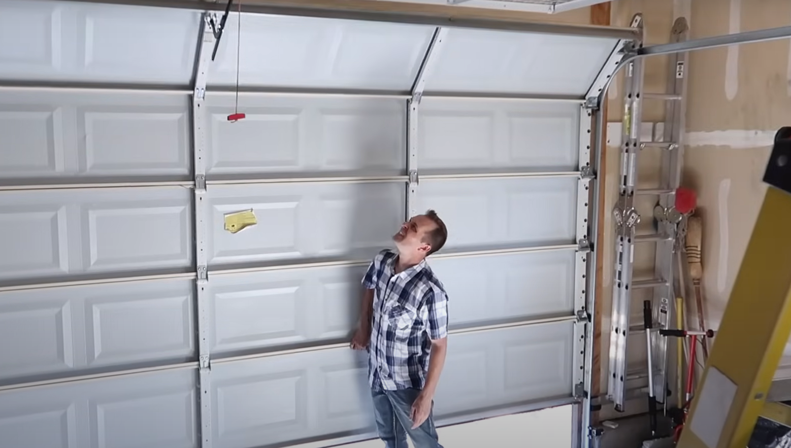 a professional technician installing a modern garage door in a residential setting in Weston, FL.