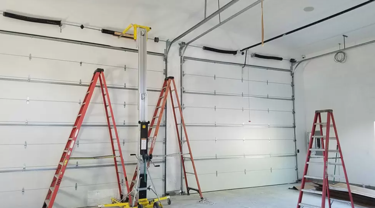 Alt text: A technician repairing a garage door with various tools in Weston, FL, showcasing professional garage door repair services.