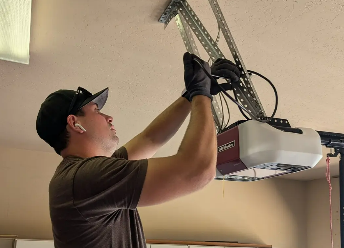 Professional garage door opener installation in Weston, FL showcasing a skilled technician installing a modern garage door opener system in a residential setting.