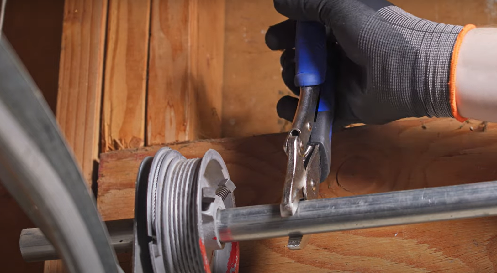 A skilled technician examining a garage door cable for repair in Weston, FL, representing Garage Door Repair Services.